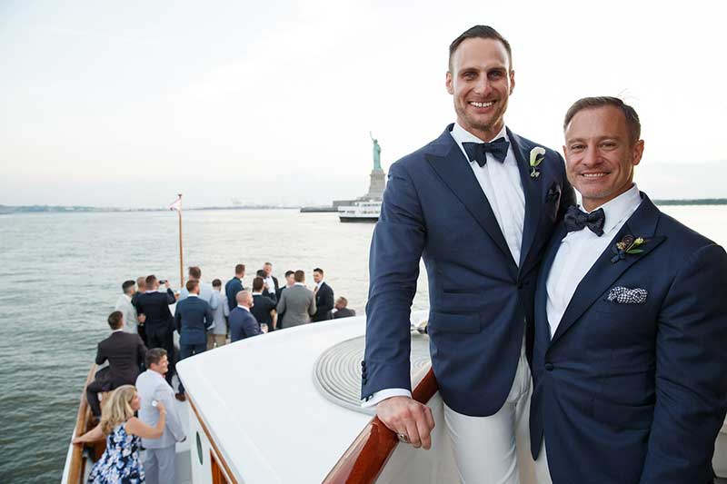 Destination wedding photographer Laurie Rhodes captures Brian and David with Statue of Liberty in the background